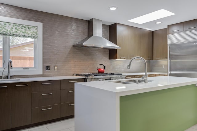 4615 11th St, Lubbock, TX 79416 - kitchen featuring wall chimney range hood, modern cabinets, a skylight, light countertops, and recessed lighting