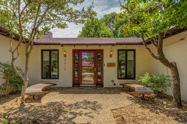 4615 11th St, Lubbock, TX 79416 - property entrance featuring brick siding and a chimney
