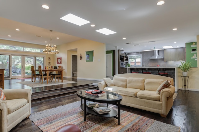 4615 11th St, Lubbock, TX 79416 - living area with recessed lighting, a chandelier, dark wood-type flooring, and a skylight