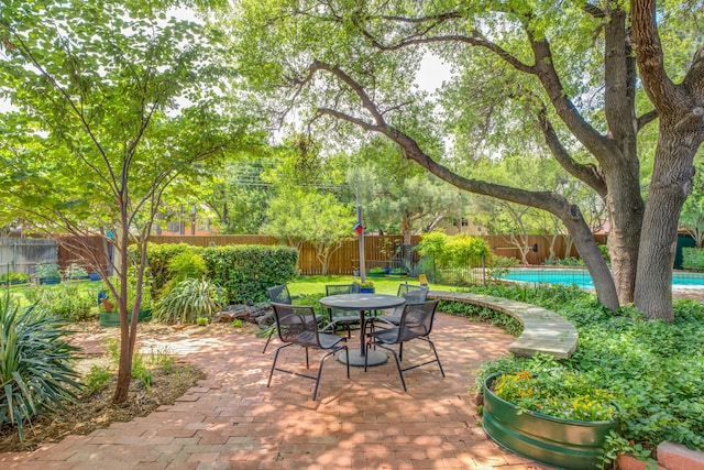 4615 11th St, Lubbock, TX 79416 - fenced backyard featuring a patio area and outdoor dining area