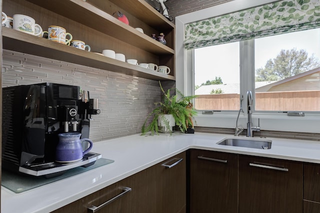 4615 11th St, Lubbock, TX 79416 - kitchen with open shelves, dark brown cabinetry, light countertops, and backsplash