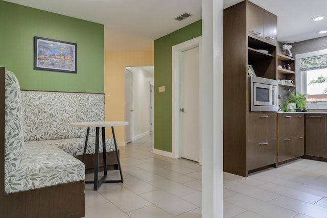 4615 11th St, Lubbock, TX 79416 - sitting room featuring baseboards and light tile patterned flooring