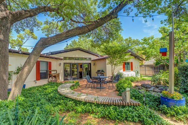 4615 11th St, Lubbock, TX 79416 - rear view of house with a patio and stucco siding