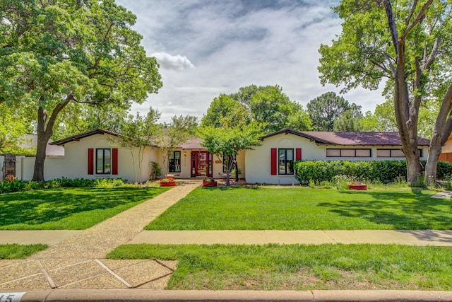 4615 11th St, Lubbock, TX 79416 - ranch-style house with a front lawn and stucco siding
