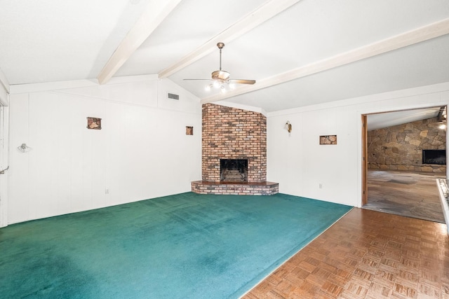 unfurnished living room with lofted ceiling with beams, ceiling fan, carpet, and a fireplace