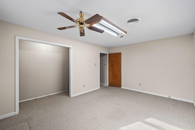 unfurnished bedroom with ceiling fan and carpet floors