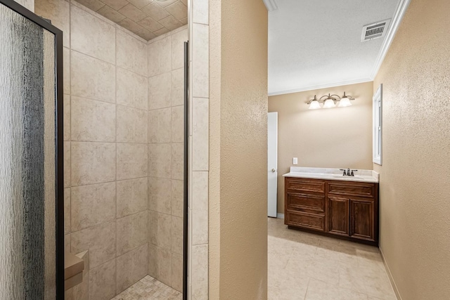 bathroom featuring ornamental molding, vanity, tile patterned floors, and a shower with shower door