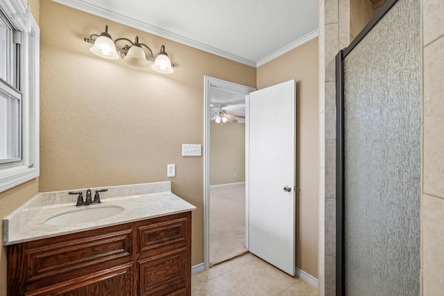 bathroom with a shower with door, crown molding, tile patterned flooring, and vanity