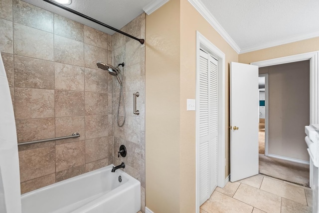 bathroom with tiled shower / bath, tile patterned floors, a textured ceiling, and crown molding