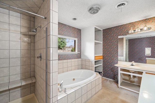 bathroom featuring vanity, shower with separate bathtub, and a textured ceiling