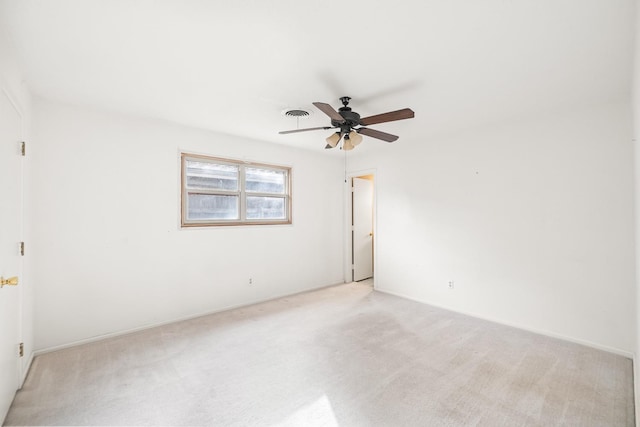 carpeted spare room with ceiling fan