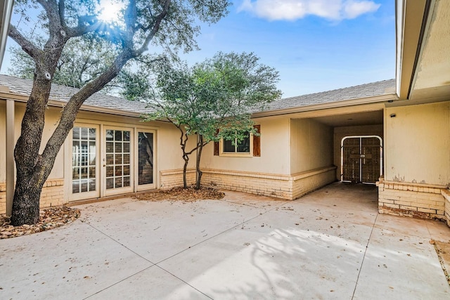 rear view of house with french doors and a patio