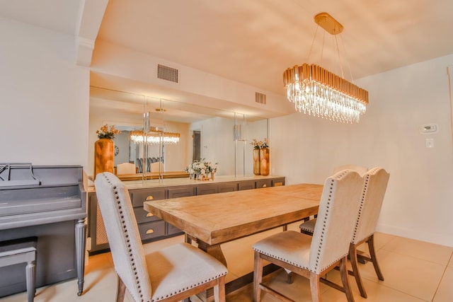 tiled dining room featuring an inviting chandelier