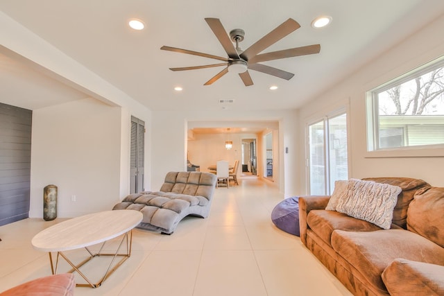 tiled living room featuring ceiling fan