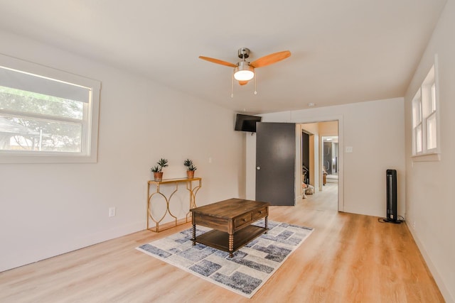 sitting room with light hardwood / wood-style floors and ceiling fan