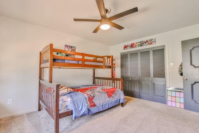 carpeted bedroom featuring a closet and ceiling fan