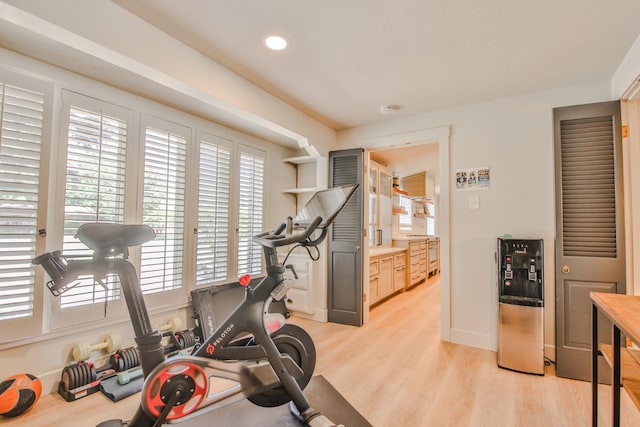 workout room with light hardwood / wood-style flooring