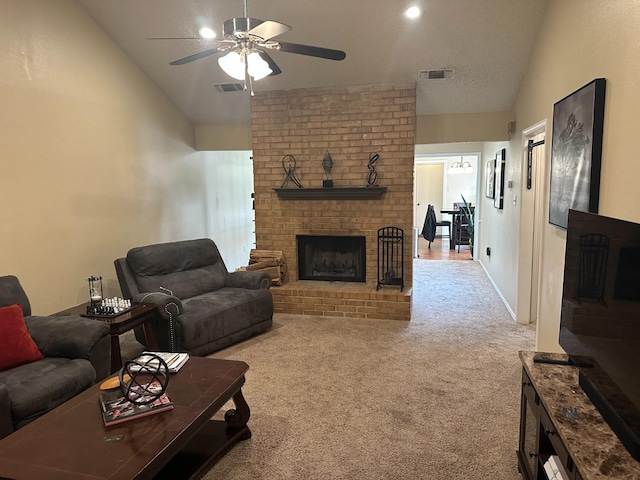 living room featuring ceiling fan, lofted ceiling, a brick fireplace, and light carpet