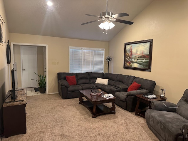 carpeted living room featuring ceiling fan and vaulted ceiling