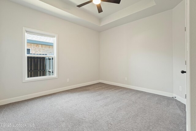 1016 N Genoa Ave, Lubbock, TX 79416 - unfurnished room featuring ceiling fan, carpet flooring, and a tray ceiling