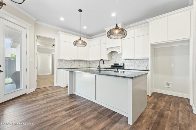 1016 N Genoa Ave, Lubbock, TX 79416 - kitchen with stainless steel stove, white cabinetry, backsplash, dark wood-type flooring, and ornamental molding