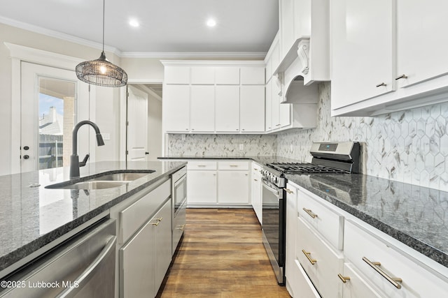 1016 N Genoa Ave, Lubbock, TX 79416 - kitchen with appliances with stainless steel finishes, ornamental molding, white cabinetry, premium range hood, and decorative light fixtures