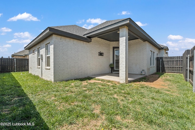 1016 N Genoa Ave, Lubbock, TX 79416 - back of house featuring brick siding, a patio area, a fenced backyard, and roof with shingles