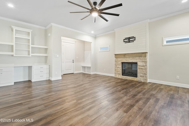 1016 N Genoa Ave, Lubbock, TX 79416 - unfurnished living room with a ceiling fan, wood finished floors, recessed lighting, crown molding, and a stone fireplace