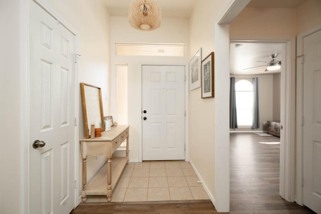 foyer entrance featuring ceiling fan and light wood-type flooring