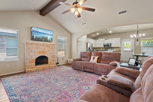 7905 Ave K, Lubbock, TX 79423 - living area with a ceiling fan, wood finished floors, a chandelier, a stone fireplace, and recessed lighting