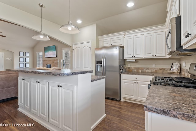 7905 Ave K, Lubbock, TX 79423 - kitchen featuring appliances with stainless steel finishes, lofted ceiling, a center island, white cabinets, and dark wood finished floors