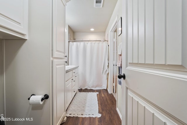 7905 Ave K, Lubbock, TX 79423 - bathroom with wood finished floors, vanity, curtained shower, and recessed lighting