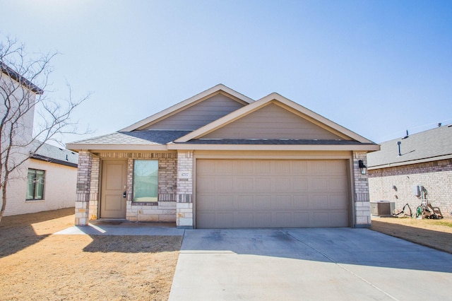 view of front facade featuring brick siding, roof with shingles, concrete driveway, an attached garage, and stone siding