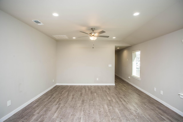 unfurnished room featuring recessed lighting, baseboards, and wood finished floors