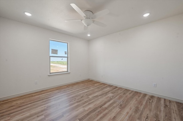 empty room with light hardwood / wood-style flooring and ceiling fan