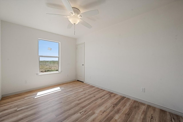 empty room featuring ceiling fan and light wood-type flooring