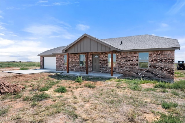 single story home featuring a porch and a garage