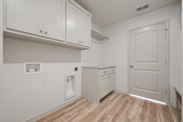 washroom with hookup for a washing machine, hookup for an electric dryer, cabinets, and light hardwood / wood-style flooring