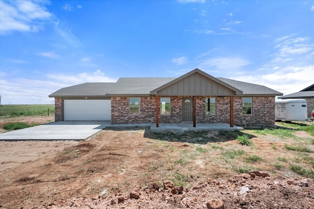 ranch-style house with a porch and a garage