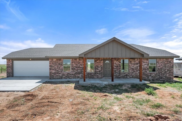 ranch-style house with covered porch and a garage