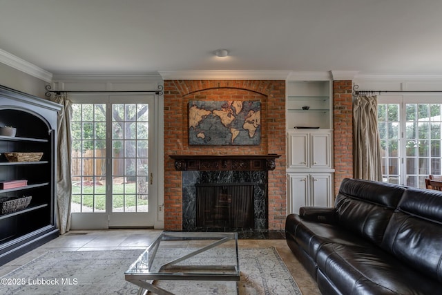 4204 89th St, Lubbock, TX 79423 - living area featuring crown molding, plenty of natural light, built in shelves, a fireplace, and tile patterned flooring