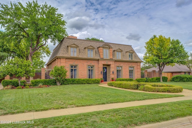 4204 89th St, Lubbock, TX 79423 - view of front facade with mansard roof, brick siding, and a shingled roof