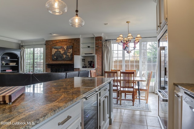 4204 89th St, Lubbock, TX 79423 - kitchen with wine cooler, a chandelier, white dishwasher, light tile patterned floors, and ornamental molding
