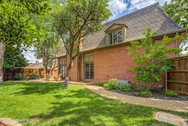 4204 89th St, Lubbock, TX 79423 - back of property featuring brick siding, a shingled roof, and a patio area