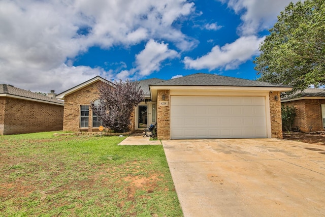 ranch-style house featuring a front yard and a garage