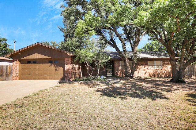 ranch-style house with a garage and a front lawn