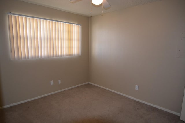 unfurnished room with carpet floors and ceiling fan