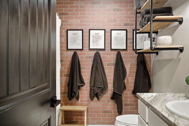 7502 103rd St, Lubbock, TX 79424 - bathroom featuring vanity and brick wall
