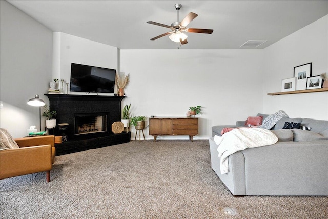 7502 103rd St, Lubbock, TX 79424 - living room with carpet floors, ceiling fan, and a fireplace with raised hearth