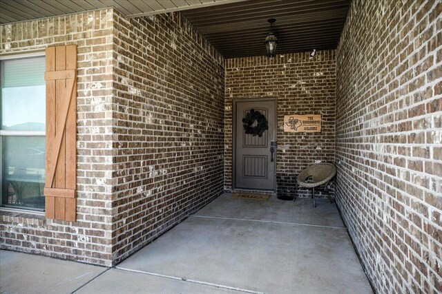7502 103rd St, Lubbock, TX 79424 - view of exterior entry featuring brick siding